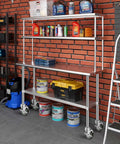 4 Inch Prep Table Caster Wheels Set Of 4 With Expanding Stem installed on a stainless steel shelving unit in a workshop.