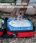Philips HeartStart OnSite AED defibrillator in blue housing inside a red carrying case outdoors