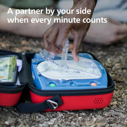 Front view of Philips HeartStart OnSite AED in a red carrying case with blue unit and clear defibrillator pads