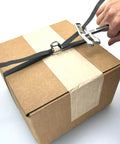 Portable One Half Inch Polypropylene Strapping Kit With Mini Coil Tool And Buckles in use on a cardboard box