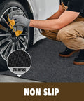 Oil Spill Mat For Garage Floor 3 By 7 Feet Under Motorcycle Waterproof Durable Non Slip TPR Backing Reusable Absorbent Pad Charcoal Heavy Duty Oil And Water Drip Catcher For Workshop And Garage, shown placed under a wheel with a man cleaning.