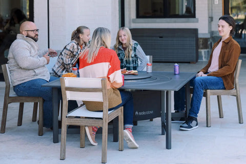 Group enjoying outdoor meal with Surround Surface For Yukon Fire Pit Lid Durable Cold Rolled Steel Shield Doubles As Backyard Tabletop Centerpiece 34.5 Inch Diameter Weatherproof Protection And Easy Storage