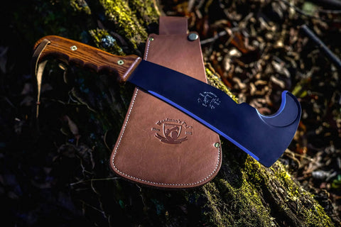 All In One Survival Machete And Brush Axe With Sheath For Camping Fishing Hunting And Bushcraft A Heavy Duty Outdoor Tool on forest floor.