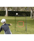 PitchBack Baseball And Softball Pitching Net And Rebounder For Fielding Practice in use by child, black and red, steel frame, outdoors