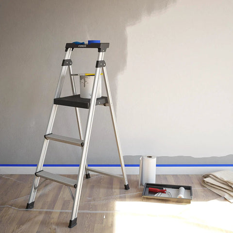 3 Step Lightweight Aluminum Folding Step Ladder With Non Marring Leg Tips Slip Resistant Platform ANSI Rated 225 Lbs Super Light Folds Flat For Quick Storage At Home Or Garage, on painted wall
