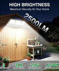 Kickin Outdoor Solar Motion Sensor Flood Lights With 2500LM 286 LEDs illuminating wooden shed at night