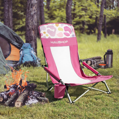 Low Seat Beach Chair With Mesh Back And Cup Holder lightweight foldable camping chair on grass beside campfire and tent