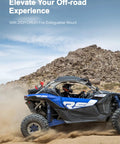 Off-road vehicle equipped with Gear Up With A Quick Release UTV Fire Extinguisher Mount Kit climbing rocky terrain