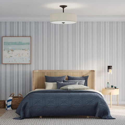 Inspire Collection Antique Bronze Three Light Semi Flush Mount Ceiling Light for bedrooms with blue bedding and striped walls