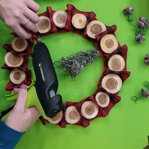 Person using 100 Watt High Temperature Heavy Duty Hot Glue Gun For Packaging Woodworking DIY Repairs And Crafts Beast Pro Grade Power Melt Fast And Consistent Bonds For Demanding Projects to glue a wreath