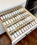 Heavy Duty Clear Acrylic Spice Drawer Organizer 4 Tier 2 Pack Slick Expandable Seasoning Rack Top Shelf Kitchen Countertop Tray Game Changer For Drawers And Cabinets with jars organized in a drawer.