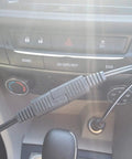 Close-up of a 12V Trickle Charger Extension Cable Kit with SAE Connectors and Battery Clamps in a car dashboard setup.