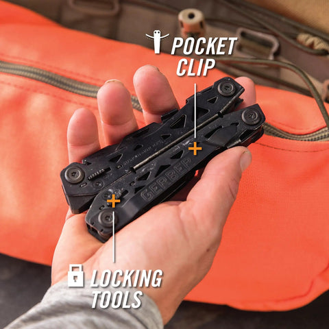 Hand holding black Suspension NXT 15 In 1 EDC Multitool with pocket clip and locking tools near orange bag