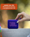 Go 4 Bluetooth Speaker Tiny But Mighty Ultra Portable Waterproof And Dustproof With Punchy Bass Pro Sound 7 Hour Battery Life Built With Recycled Materials Purple For Outdoors And Travel held in hand.