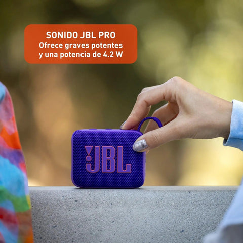 Go 4 Bluetooth Speaker Tiny But Mighty Ultra Portable Waterproof And Dustproof With Punchy Bass Pro Sound 7 Hour Battery Life Built With Recycled Materials Purple For Outdoors And Travel held in hand.
