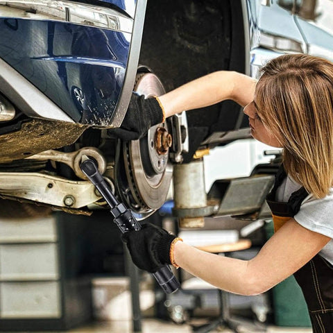 Mechanic using 12V Li-Ion Cordless 3/8 Inch Extended Drive Ratchet Wrench Kit With Built-In LED Light on car wheel