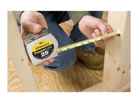 Person using Power Return Rule Tape Measure 25 Foot Yellow With Locking Blade, Powerlock II Style for framing measurement.