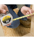 Person using Power Return Tape Measure 25 Ft With Locking Blade That Prevents Creeping, Tru Zero Hook in carpentry work