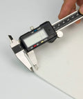 Gasket paper sheet, 1/8 in thick, light-gray, measured with digital caliper