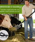 Man using Rugged 46 Inch Garden Pitch Fork With Four Tines Heavy Duty Steel Ergonomic D Handle Anti Rust Coating in barn with cows.