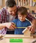 Father and son measuring wooden birdhouse in home workshop with drill bit sharpening guide jig on the table.