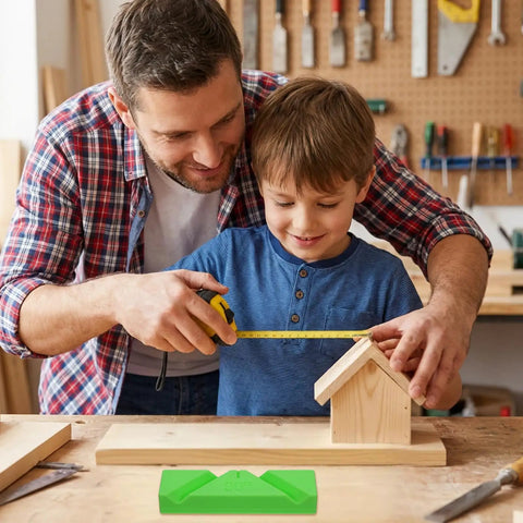 Father and son measuring wooden birdhouse in home workshop with drill bit sharpening guide jig on the table.