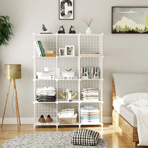 Wire Cube Storage Organizer With 12 Metal Cubes Bookshelf And Closet Storage Unit in white, holding books and clothes in bedroom.