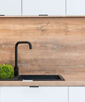 Modern kitchen with matte black faucet, wood backsplash, and cabinets featuring 6 Pack Finger Edge Pulls For Cabinets 80mm Length Matte Black.