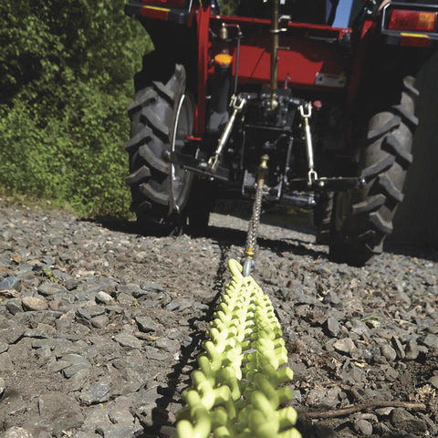 Heavy Duty Triple Chain Shrub And Clump Remover Tool With Four Foot Pulling System attached to tractor on rocky ground