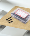 Crib Screws Replacement Set Delta Hex Socket Cap Bolts Barrel Nuts Baby Bed Hardware Replacement Kit in box on wooden surface