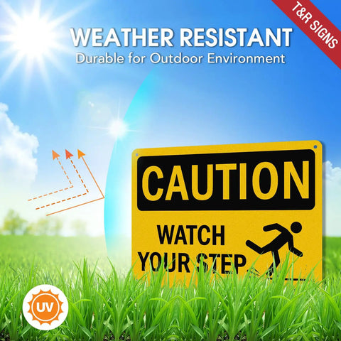 Kickass Caution Watch Your Step Signs 2 Pack 10 X 7 Inch Rust Free Reflective Aluminum Safety Plaque Weatherproof Warning Sign in grass.