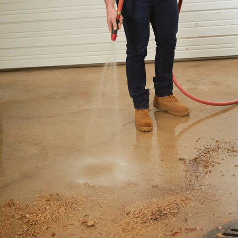 Person using Heavy Duty Water Hose With Commercial Grade Double Reinforced Rubber And Vinyl Abrasion Resistant Red Cover Built To Last 400 PSI Burst Strength Three Quarter Inch By Fifty Foot Garden Hose For Durable Kink Resistant Yard Work on driveway.