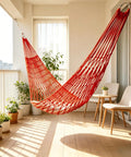 Thickened Nylon Hammock With Breathable Mesh in red, hanging on a balcony, perfect for garden or camping and backyard chill sessions.