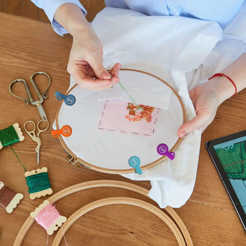 Embroidery setup with colorful floss and tools, featuring Magnetic Cable Clips Set Of 12 for Cable Management and Organization