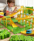 Child playing with Epic 4 Tier Puzzle Race Car Track Set for Kids Ages 3 to 8 with 51 pieces, featuring bridges and road signs.