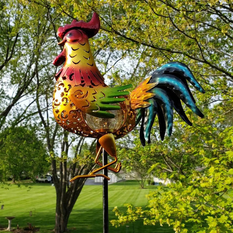 Colorful rooster metal statue in garden setting with greenery, Rooster Solar Lights Outdoor Decor For Garden Yard Art Statue on display.