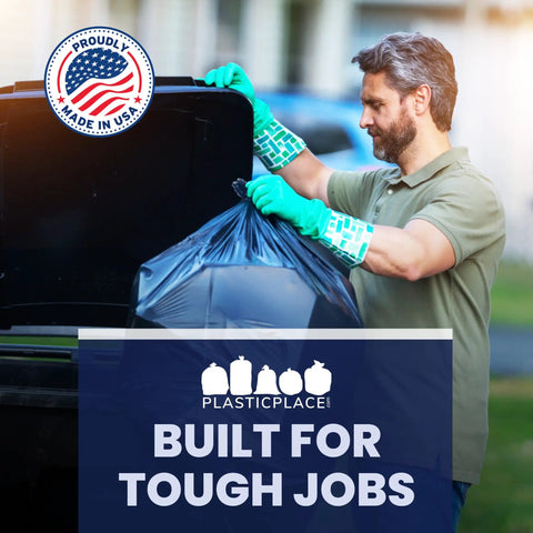 Man using Beefy Heavy Duty 55-60 Gallon Contractor Trash Bags, 1.2 Mil Black Puncture Resistant Garbage Bags for outdoor cleanup.