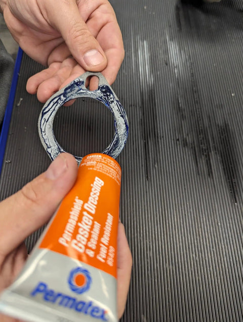 Fuel-Resistant Gasket Dressing And Sealant, Orange, 2 Oz Tube applied to metal gasket for metal-to-metal joint sealing