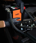 User installing Heavy Duty Silicone Car Battery And Engine Block Heater Pad With Quick Ice Melter Shield on battery.
