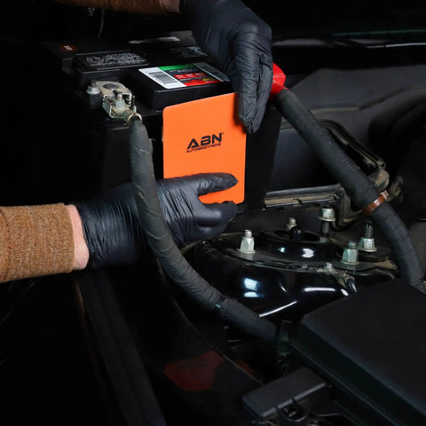 User installing Heavy Duty Silicone Car Battery And Engine Block Heater Pad With Quick Ice Melter Shield on battery.