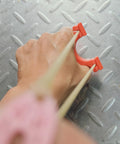 Ultra Compact Mini Slingshot With Flat And Round Bands In Red Nylon Fiber, Ambidextrous And Pocket Sized For On The Go held in hand