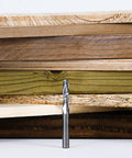 SpeTool 1/4 in upcut spiral router bit with 1/4 in shank, solid carbide, standing in front of plywood boards