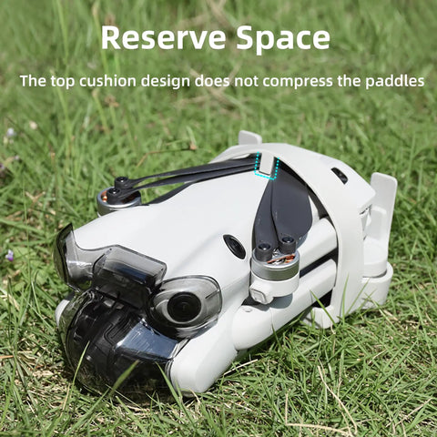 DJI Mini 4 Pro Propeller Guard Strap Holder in use with drone on grass, showcasing secure propeller protection