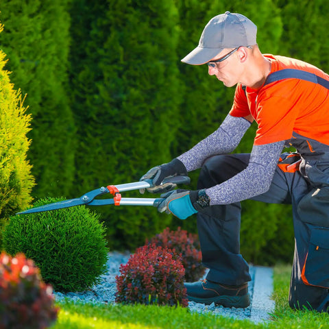 Gardener wearing 5 Pack Cut Resistant Arm Sleeves With Thumb Hole Guards For Gardening, HPPE Durable Shield, trimming bushes