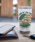 Patriotic Insulated Tumbler With US Flag Sailboat Motif Red White And Blue Stainless Steel Travel Mug on table with phone and keys.
