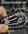 Hand holding Sprocket Fidget Bike Chain Hand Roller For Anxiety Relief And Sensory Fun on a desk