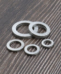 Five manganese steel wedge lock washers, assorted sizes (M8–M20).