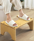 Person using Bamboo Poop Stool 7 Inch Toilet Step for Easy Pooping and Squatting, wood bathroom foot stool, anti slip layer visible