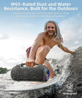 Man surfing with 200W Peak Portable Bluetooth Speaker With Deep Bass That Hits Different, IP65 Waterproof, next to him