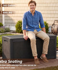 Heavy Duty 160 Gallon Deck Box Crafted From Weatherproof Resin With Secure Locking Lid, man sitting on box in backyard.